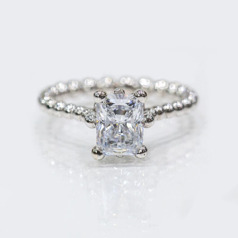 Ken Black of Atlanta Diamond Company created the Queen cut diamond as an alternative to the traditional Princess cut. The Queen cut has more facets and is more brilliant than a Princess cut.