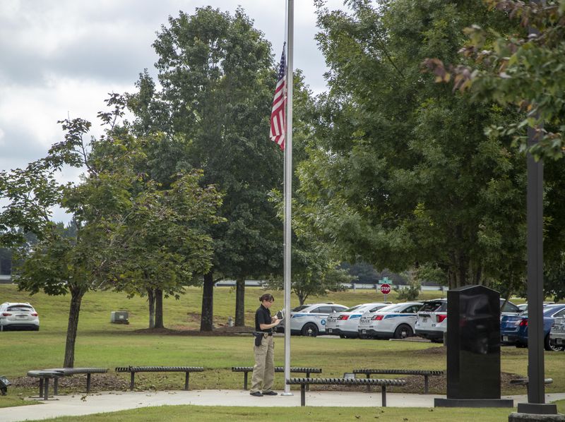 An American flag is placed at half-staff following the death of a Gwinnett County Police Department recruit.
