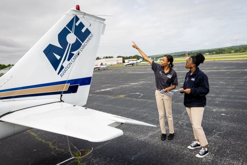 Aviation Career Enrichment Academy flight instructor Ashley Moss (Left) performs a preflight check on a Cessna 172 with student pilot Kelsey Griffin, 15, before their flight at Brown Field In Atlanta. (Steve Schaefer / AJC)