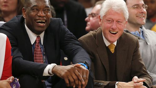 Former President Bill Clinton, right, sits with former NBA basketball player Dikembe Mutombo during the first half of the NBA All-Star game, Sunday, Feb. 15, 2015, in New York. (AP Photo/Kathy Willens)
