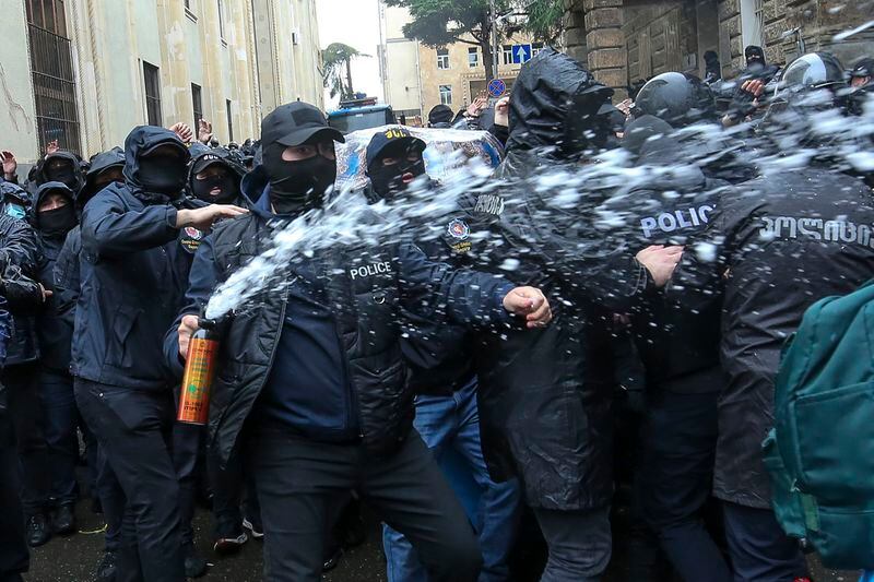 Police use a spray to block demonstrators near the Parliament building during an opposition protest against "the Russian law" in the center of Tbilisi, Georgia, on Monday, May 13, 2024. Daily protests are continuing against a proposed bill that critics say would stifle media freedom and obstruct the country's bid to join the European Union. (AP Photo/Zurab Tsertsvadze)