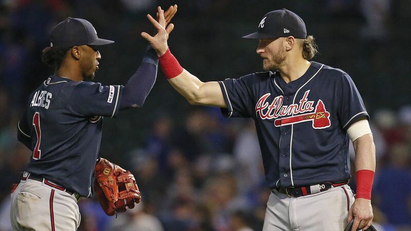 Braves teammates Ozzie Albies and Josh Donaldson celebrate after their team's 5-3 win over the Chicago Cubs June 26, 2019, at Wrigley Field in Chicago.