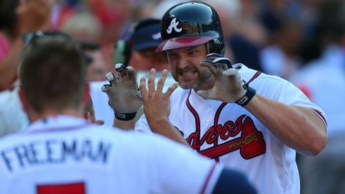 David Ross, right, of the Braves reacts as he is greeted by teammates after his two-run homer against the St. Louis Cardinals in the second inning of the National League wild-card game at Turner Field in Atlanta on Friday, Oct. 5, 2012. CURTIS COMPTON / CCOMPTON@AJC.COM