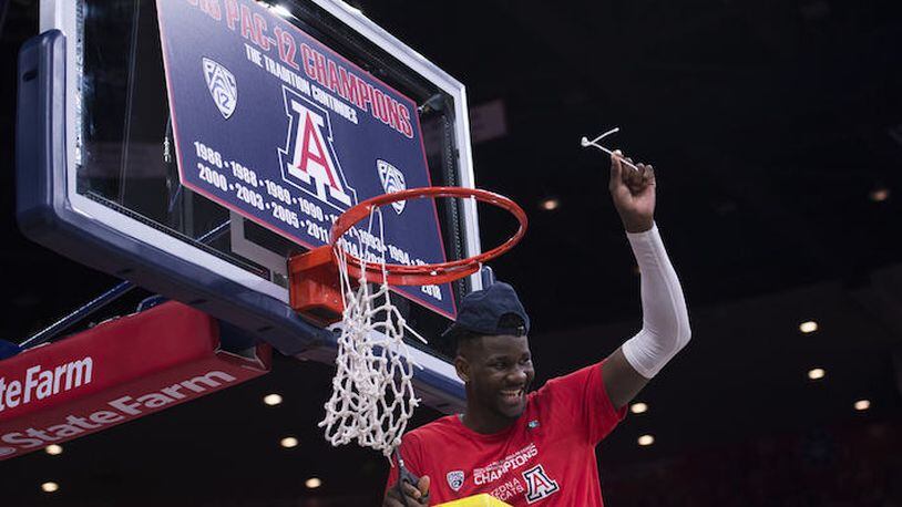 In a March 3, 2018, file image from Tucson, Ariz., Arizona's Deandre Ayton smiles after cutting the net after winning the regular season Pac 12 Conference Championship. (Jeff Brown/Zuma Press/TNS)