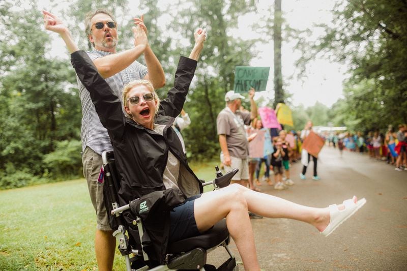 Katherine and Jay Wolf cheer at Hope Heals Camp, the camp their non-profit offers to families affected by disabilities. 