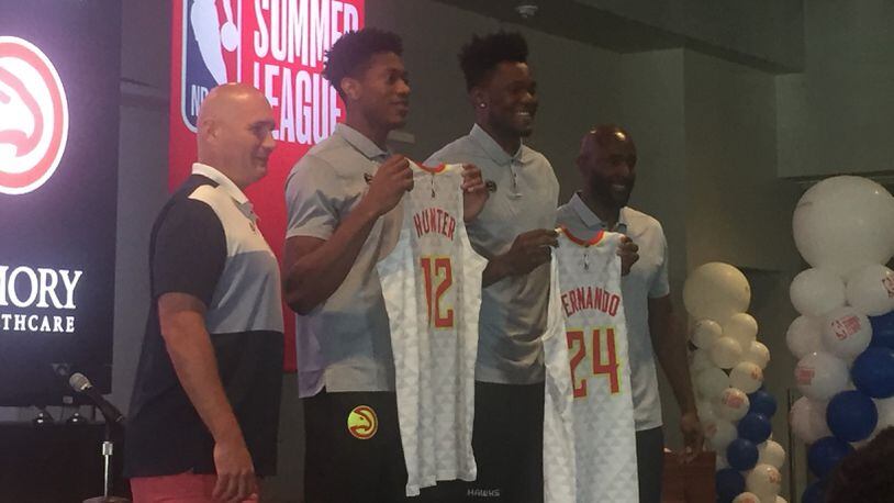 Hawks draft picks De'Andre Hunter and Bruno Fernando (second and third from left) pose with their jerseys with general manager  Travis Schlenk (left) and head coach Lloyd Pierce (right) at an introductory press conference in Las Vegas Sunday.