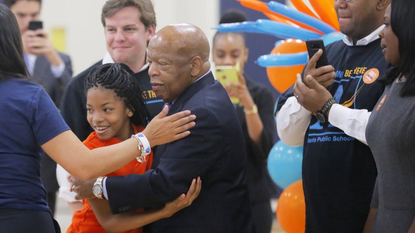 John Lewis gave hugs for the first day of school at the John Lewis Invictus Academy. Lewis, a longtime congressman from Atlanta and civil rights activist, died in 2020. AJC FILE PHOTO.
