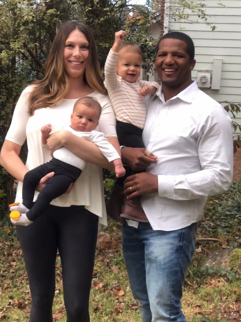 Former Georgia Tech captain Roddy Jones and his family: his wife, Jackie, and daughters Jacey (raising fist) and Adrie (with the decorated socks). (Courtesy of Roddy Jones)