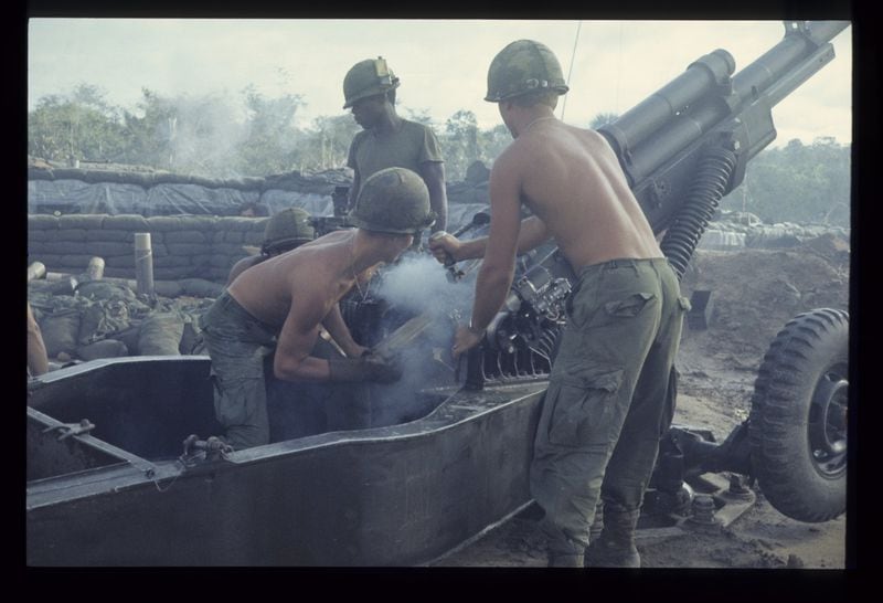 Soldiers man a howitzer during an artillery attack in a photo by 1st Lt. James H. Holcombe Jr., a Tucker resident who snapped perhaps 600 color photographs during his service in Vietnam. His photos are part of a new exhibit at the Atlanta History Center. CONTRIBUTED BY JAMES H. HOLCOMBE JR.