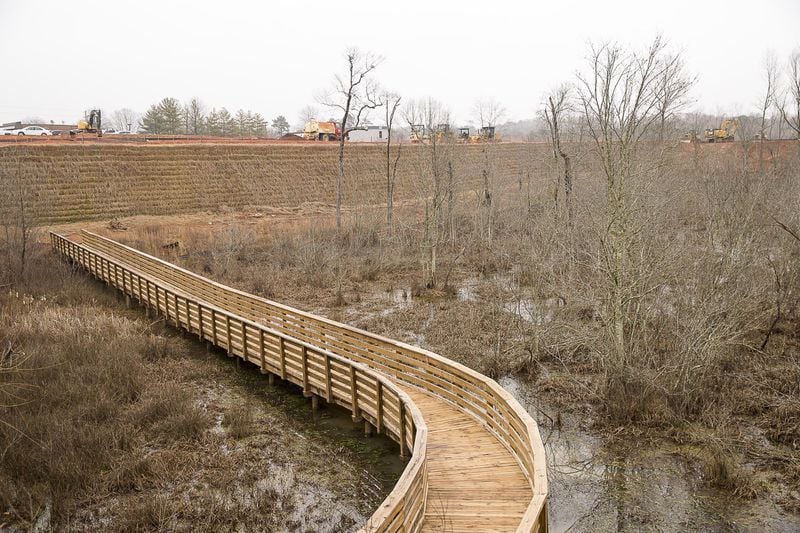 A new bridge under construction that will connect to Big Creek Greenway sits near the Halcyon mixed-use development construction site in Forsyth County on February 11, 2019. 