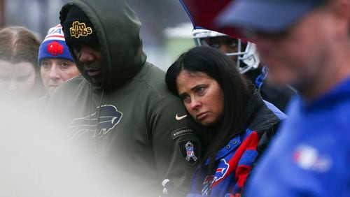 Thurman Thomas, left, and Patti Thomas, right, listen during a prayer circle for Buffalo Bills' Damar Hamlin on Tuesday, Jan. 3, 2023, in Orchard Park, N.Y. The family of Damar Hamlin expressed gratitude for the outpouring of support shown toward the Buffalo Bills safety who suffered cardiac arrest after making a tackle while asking everyone to keep the hospitalized player in their prayers on Tuesday.(AP Photo/Joshua Bessex)