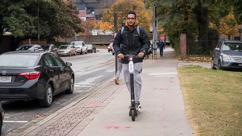 A man rides a Bird Scooter on Georgia Tech's campus in Atlanta.