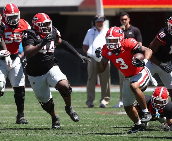 Georgia defensive lineman Jordan Hall (left) moves in to tackle running back Andrew Paul.  Curtis Compton for the Atlanta Journal Constitution