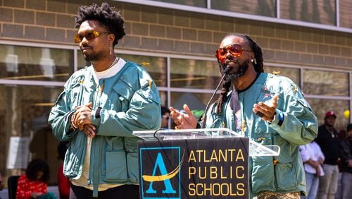 WowGr8 aka Doctur Dot and Olu aka Johnny Venus speak to unveil a new community garden at Jean Childs Young Middle School in Atlanta on Thursday, March 30, 2023. Olu and WowGr8 of hip-hop group Earthgang helped sponsor the project. (Arvin Temkar / arvin.temkar@ajc.com)