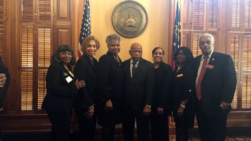 U.S. Rep. John Lewis, D-Atlanta, center, has his photo taken with members of the Georgia House on Wednesday. ERICA A. HERNANDEZ / ERICA.HERNANDEZ@AJC.COM