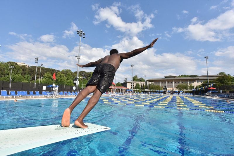 A swimmer jumps off the diving board at the Emory Aquatics Center at the Student Activity and Academic Center on May 10, 2016. HYOSUB SHIN / HSHIN@AJC.COM