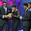 Anita Baker reacts as she receives Legend Award from Michael Baisden (left) during the 2010 Soul Train Awards at the Cobb Energy Performing Arts Centre on Wednesday, Nov. 10, 2010.