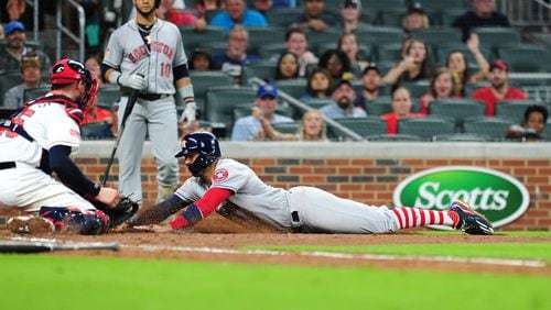 Braves catcher Tyler Flowers tags out the Astros' Carlos Correa at home in the fourth inning SunTrust Park on July 4, 2017, in Atlanta.