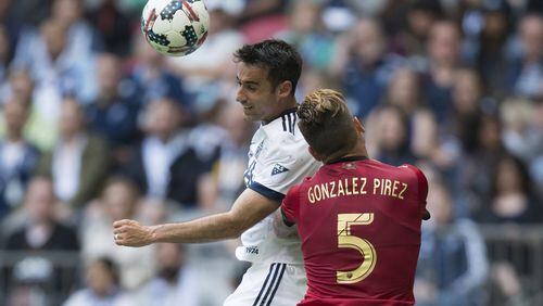 Vancouver Whitecaps’ Andrew Jacobson, left, and Atlanta United’s Leandro Gonzalez Pirez vie for the ball during their MLS soccer match Saturday, June 3, 2017, in Vancouver, British Columbia. (Darryl Dyck/The Canadian Press via AP)
