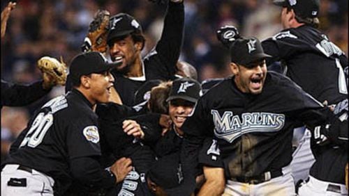 The 2003 Marlins celebrate after their World Series win against the Yankees. That’s 20-year-old rookie Miguel Cabrera at lower left. (AP file photo)