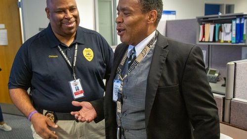 Gwinnett’s new Democratic solicitor general, Brian Whiteside (right), chats with Curtis Clemons at the Gwinnett Justice and Administration Center in Lawrenceville on Friday October 11th, 2019. (Photo by Phil Skinner)