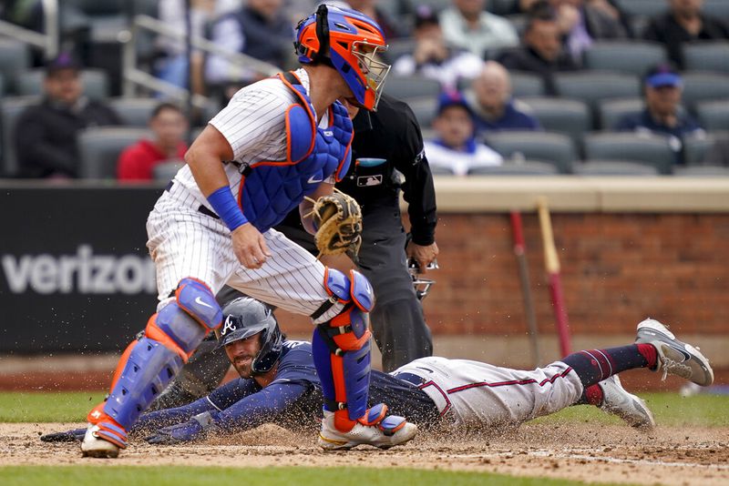 Atlanta Braves' Dansby Swanson scores on an RBI single hit by Ronald Acuna Jr. off New York Mets relief pitcher Trevor Williams in the sixth inning of a baseball game, Wednesday, May 4, 2022, in New York. (AP Photo/John Minchillo)