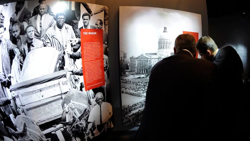 Visitors view archival images from the funeral for Martin Luther King, Jr., at the National Center for Civil and Human Rights Tuesday, June 10, 2014, in Atlanta. The NCCHR tells a story broader than the American civil rights movement, linking that movement to the international current of human rights reform that took inspiration in Atlanta. David Tulis / AJC Special