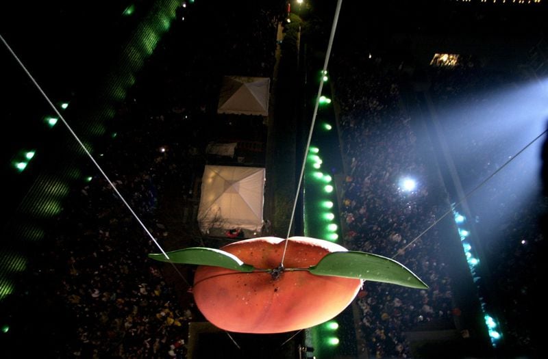The Peach Drop at Underground Atlanta has been an Atlanta tradition since 1989. The peach is eight feet tall, weighs 800 pounds and takes 53 seconds to makes its way down the tower. Atlanta Journal-Constitution archive image by Ben Gray