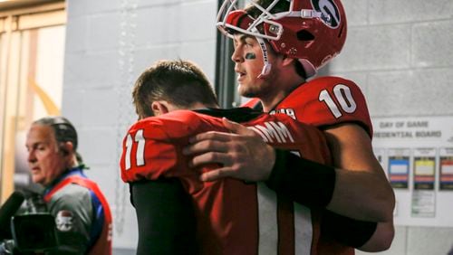 Jacob Eason (right) comforts starting quarterback Jake Fromm (11) after the Bulldogs' lost to the Alabama in the  College Football Playoff  Championship Monday, Jan. 8, 2018, at Mercedes-Benz stadium in Atlanta.
