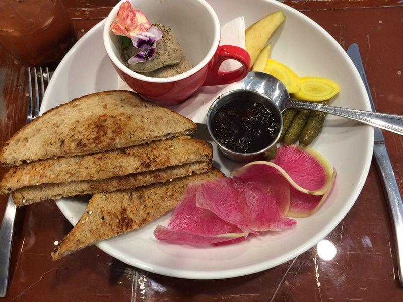 The chicken liver mousse at Petit Chou comes with toast, jam and cornichons, plus fresh apple, yellow carrot and watermelon radish slices.