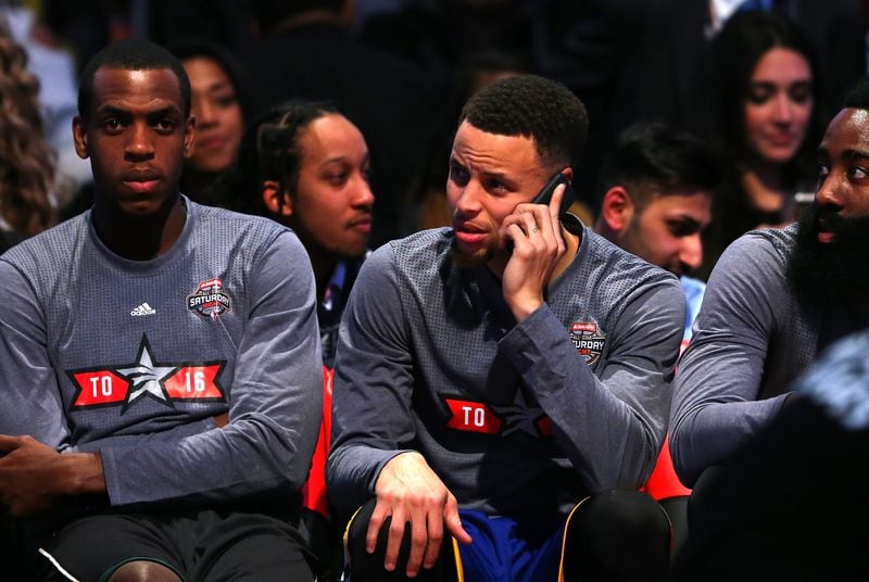 TORONTO, ON - FEBRUARY 13: Stephen Curry of the Golden State Warriors speaks on a cell phone on the bench in the Taco Bell Skills Challenge during NBA All-Star Weekend 2016 at Air Canada Centre on February 13, 2016 in Toronto, Canada. NOTE TO USER: User expressly acknowledges and agrees that, by downloading and/or using this Photograph, user is consenting to the terms and conditions of the Getty Images License Agreement. (Photo by Elsa/Getty Images)