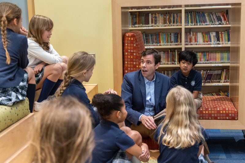 Cornerstone Academy Headmaster Colin Creel (third from right) reads to a class of students the library. For the Top Workplace small sized business. PHIL SKINNER FOR THE ATLANTA JOURNAL-CONSTITUTION