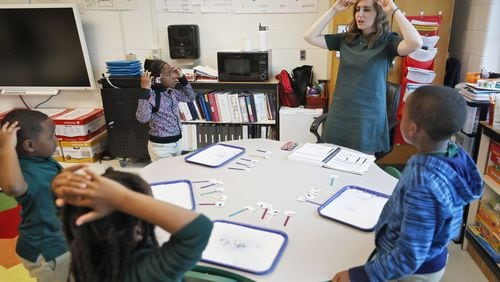 Jennifer Henderson, lead literacy center teacher, works on a word “stretching” activity at Charles R. Drew Charter School. It helps students break words into sounds.