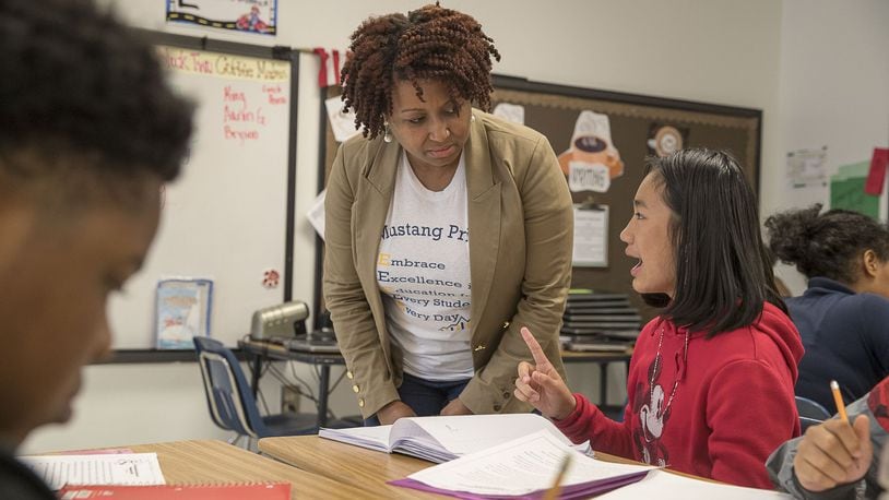 Cliftondale Elementary School principal Miranda Freeman interacts with a fifth grader who is completing a writing prompt at the school in College Park, Monday, November 11, 2019. ALYSSA POINTER/ATLANTA JOURNAL CONSTITUTION