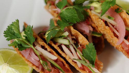Ahi Tacos- crispy taco shell, fresh tuna, crunchy vegetables and spicy avocado aioli.