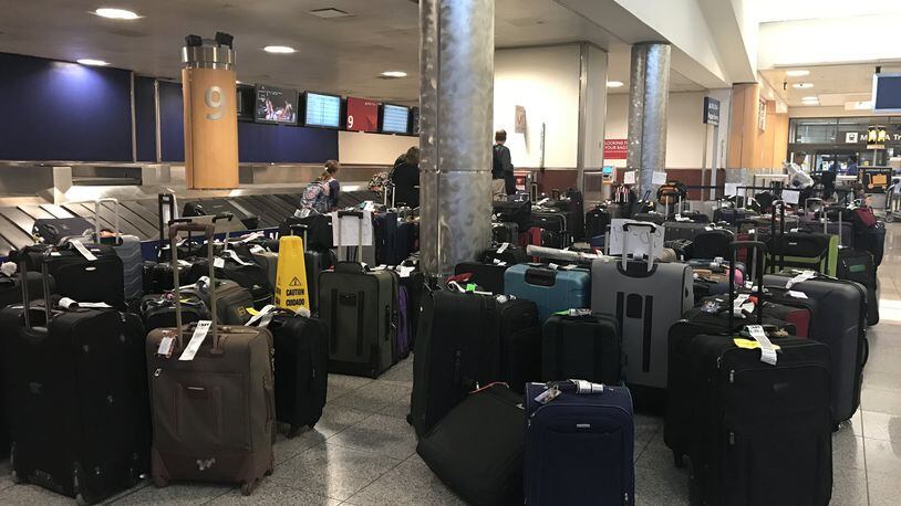 Hundreds of bags were left on the floor at Delta baggage claim at the Atlanta airport in the aftermath of the airline’s flight cancellations last week. (Kelly Yamanouchi, The Atlanta Journal-Constitution)
