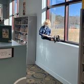 A child has a bird's-eye seat reading a book at the main branch of the Athens-Clarke County Library. (Courtesy of Molly Pratt)