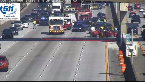 Emergency crews  temporarily shut down left lanes in both directions on I-285 at South Atlanta Road after an overturned vehicle crash Tuesday.