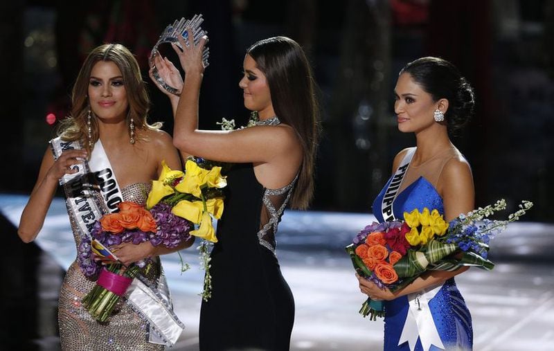 Former Miss Universe Paulina Vega, center, removes the crown from Miss Colombia Ariadna Gutierrez, left, before giving it to Miss Philippines Pia Alonzo Wurtzbach, right, at the Miss Universe pageant on Sunday, Dec. 20, 2015, in Las Vegas. Gutierrez was incorrectly named the winner before Wurtzbach was given the Miss Universe crown. AP Photo/John Locher