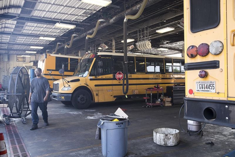 Mechanics work on Atlanta Public School busses at the Atlanta Public Schools Transportation hub in Atlanta’s Sylvan Hills community, Friday, May 31, 2019. (Alyssa Pointer/alyssa.pointer@ajc.com)