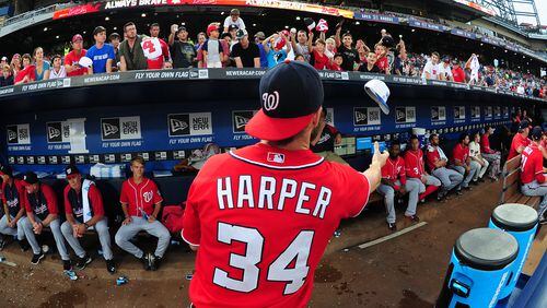 ATLANTA, GA - AUGUST 9: Bryce Harper #34 of the Washington Nationals signs autographs during a pregame rain delay against the Atlanta Braves at Turner Field on August 9, 2014 in Atlanta, Georgia. (Photo by Scott Cunningham/Getty Images)