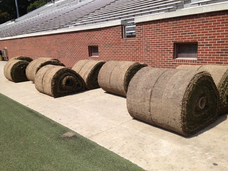 Rolls of turf waiting to be unspooled onto the field.