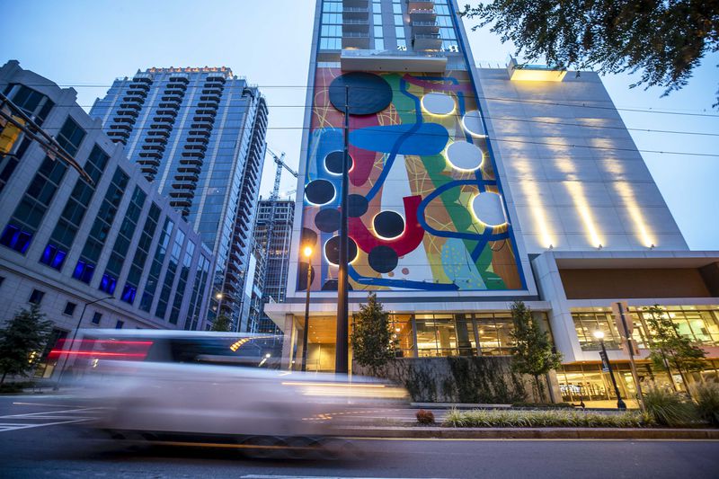 "Connect," a 10-story mural by artist Alex Webber, also known as HENSE, brightens up the side of the Icon Midtown apartment building. (Alyssa Pointer / Alyssa.Pointer@ajc.com)