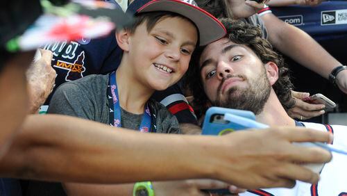 Atlanta Braves' Dansby Swanson, right, poses with 9 year old fan Caleb Zurawick of Chattanooga, Tenn., before a baseball game against the Philadelphia Phillies, Wednesday, Sept. 28, 2016, in Atlanta. (AP Photo/John Amis)