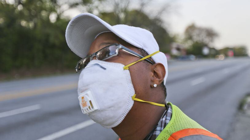 In this photo from April 11, 2013, Selena Gilreath wears a mask while working near Northside Drive in Atlanta. Pollen counts on that day rose to 8,163, the second highest count ever. JOHN SPINK / JSPINK@AJC.COM
