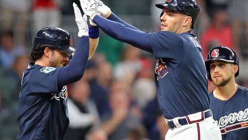 Braves rookie Dansby Swanson (left) congratulates Freddie Freeman after Freeman’s three-run homer gave the Braves a 3-2 lead over the New York Yankees in an exhibition game March 31, the Braves’ only game at SunTrust Park prior to Friday night’s home opener against the Padres. (Curtis Compton/ccompton@ajc.com)