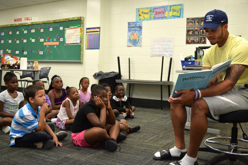 Georgia Tech guard Tadric Jackson reads to rising second graders who attend the Horizons Atlanta summer learning program that supports students from underserved communities throughout their K–12 academic careers.