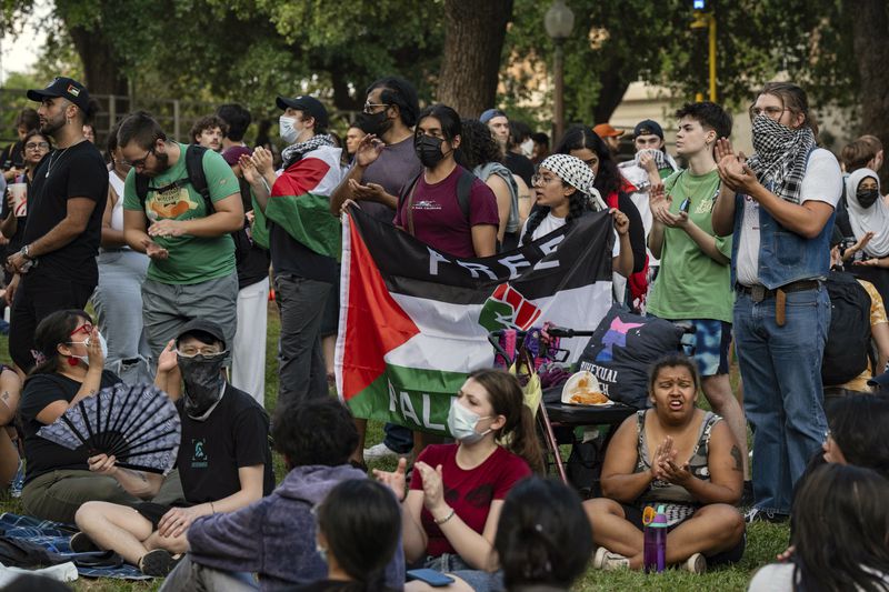 Demonstrators chant at a pro-Palestinian protest at the University of Texas Wednesday April 24, 2024 in Austin, Texas. Protests Wednesday on the campuses of at least two universities involved clashes with police, while another university shut down its campus for the rest of the week. (Mikala Compton/Austin American-Statesman via AP)
