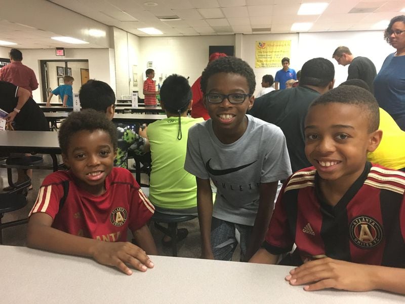 Maddox Johnson, left, came to support his brother Ellis (center) along with older brother Owen on May 18, 2018 at the 2018 WhizLearning Kids Scratch Competition at Suwanee Elementary School. Arlinda Smith Broady/AJC