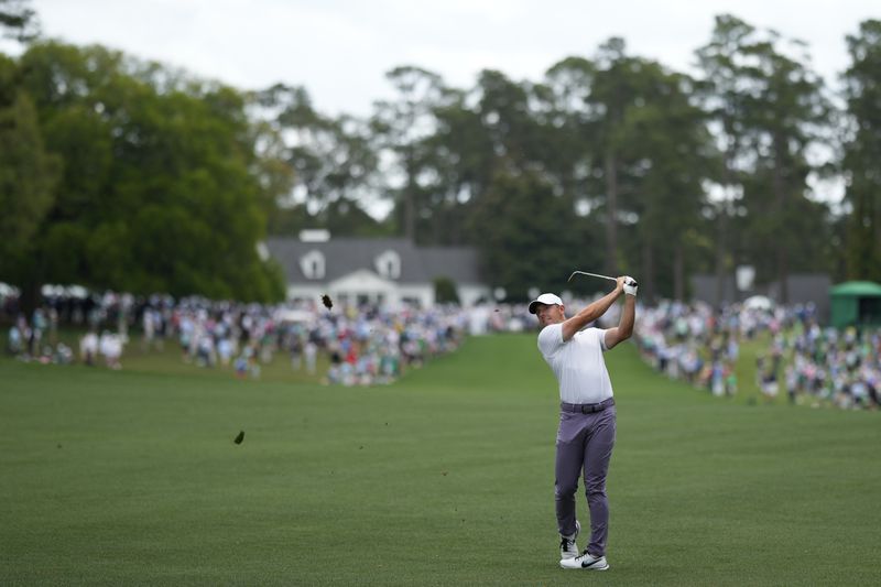 Rory McIlroy, of Northern Ireland, hits from the fairway on the first hole during the first round at the Masters golf tournament at Augusta National Golf Club Thursday, April 11, 2024, in Augusta, Ga. (AP Photo/Matt Slocum)